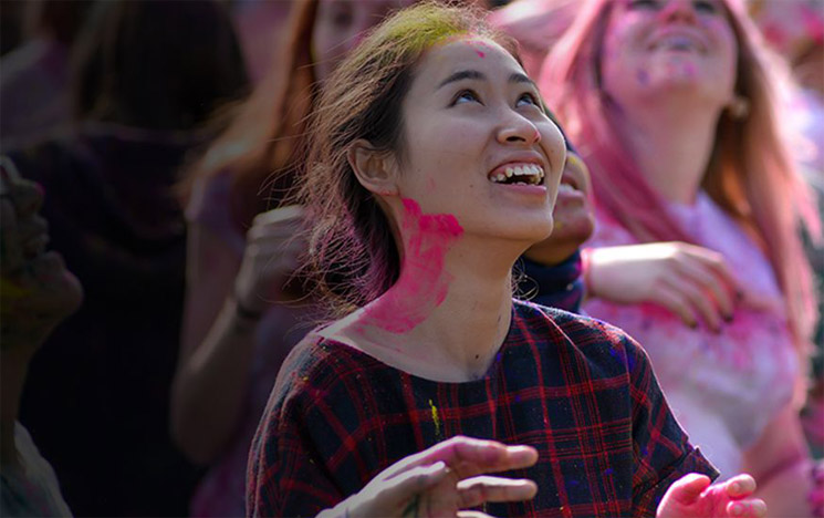 Students celebrate the Holi festival at the СƵ